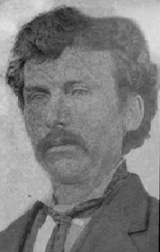 A black and white photograph featuring a man with dark hair and a mustache