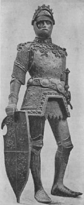 King Arthur in armor with visor raised and with jousting shield