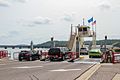 Cars drive onto the Merrimac Ferry from the landing in Merrimac in July 2015 (but also note that the Wisconsin and Southern Railroad bridge across the river is in the background)