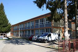 2 story building and various cars parked outside