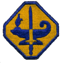 Photograph of the blue and gold octagon-shaped insignia patch for the Army Specialized Training Program (ASTP), featuring an oil lamp and sword at its center