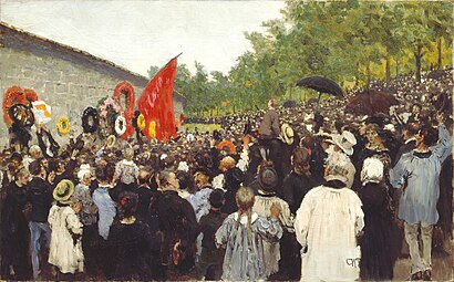 Tableau montrant une foule rassemblée devant le mur, certains portant des drapeaux rouges.