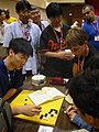 Image 16Three Japanese professional Go players observe some younger amateurs as they dissect a life and death problem in the corner of the board, at the US Go Congress in Houston, Texas, 2003. (from Go (game))