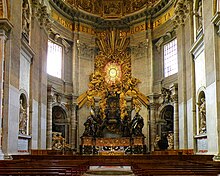 Pews before the ornate, gold-leafed throne of St. Peter