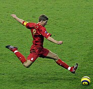 A man wearing a red football kit.