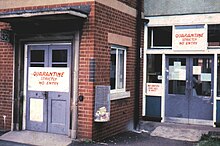 Two sealed wards of East Birmingham Hospital, with signs informing visitors of the quarantine