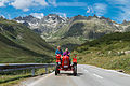 Couple driving with red tractor Porsche-Diesel Junior on the Silvretta Hochalpenstraße in Vorarlberg, Austria. July 2014. #1 in the Photo Challenge Photo Challenge Holidays, in August-September 2014.