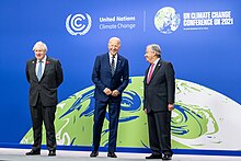 Phot of Biden, Johnson and Guterres standing onstage