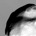 Close-up of Helene with Saturn in the background (Cassini, March 2010)