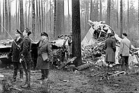 Fotografie úředníků prohlížejících vrak letadla Douglas C-47A-35-DL (DC-3, OH-LCA) Aero poblíž letiště Mariehamn v Jomale, Åland, Finsko po nehodě AY311. 1968.