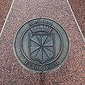 Coat of arms at twin town Celle (Germany), granite artwork below signpost