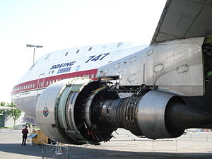 A Pratt & Whitney JT9D museum exhibit with none of the accessories, tubes, wiring and cowls which cover a functional engine. Revealed are the casings bolted together which make up the structural backbone of the engine.[142] The engine thrust is transferred to the aircraft pylon at the top of the turbine case. As this is above the engine centerline where the thrust acts it causes backbone bending in the core engine[143] which in turn causes causes blade tip rubs and performance loss.