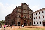 A church in red brick and an adjacent building in white