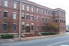 Three-story, red brick building