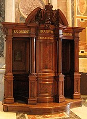 Photograph of brown, wooden confessional stand at St. Peter's Basilica