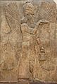 Deity representation on Assyrian relief. Blessing genie, about 716 BCE. Relief from the palace of Sargon II. Louvre AO 19865