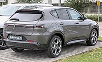 Rear-three-quarter view of a five-door car with LED taillights and an aerodynamic lip spoiler over the rear luggage hatch