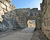 A ruined prehistoric gate built by massive stones. A relief of two lions stands above the entrance