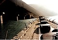 Civilian cars cross the Neretva on a UN pontoon bridge built beside the destroyed bridge