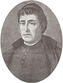 Black and white oval portrait of a priest. The image is focused on his face, looking to the left.