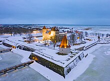 Kuressaare Castle, square stone keep with one square corner tower and red tile roof