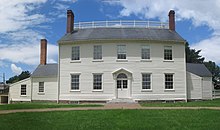 Photograph of a two-story, white clapboard house