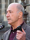 portrait of senior man speaking into microphone