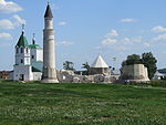 An ensemble of buildings, including a church and a minaret