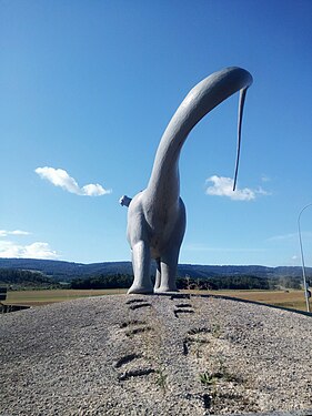 Artificial Brontosaurus and its tracks in a roudabout, Porrentruy, France