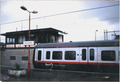 A picture of a GMPTE train at Macclesfield station in the year 2001.