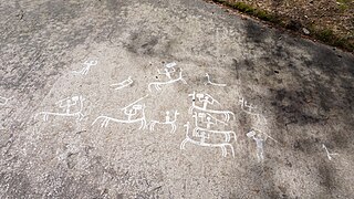 Carvings featuring horse riders at Litselby