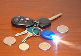 Miniature LED flashlight on a key chain, powered by lithium primary coin batteries.