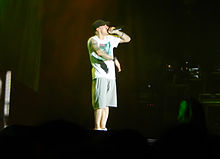 Eminem onstate in T-shirt, shorts and baseball cap