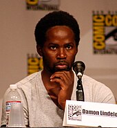 Harold Perrineau behind the microphone at a convention.