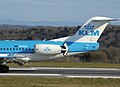 KLM Fokker 100 landing with reverse-thrust buckets deployed.