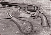 Colt 1851 Navy with powder flask.