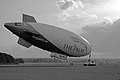 Spirit of Dubai – The Palm, on the UK leg of her 2006 tour. Note the scale of the airship from the two technicians standing below her.