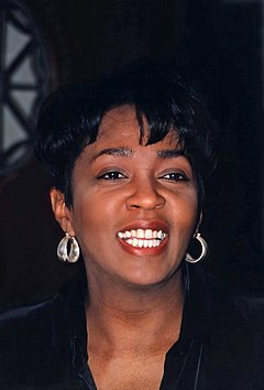 A black-haired woman smiling