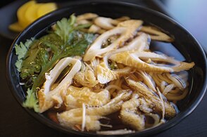 Korean udong noodles with crown daisy and eomuk (fish cakes)