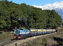 Diesel locomotive pulling seven passenger carriages