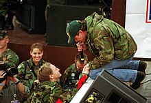 Shane Minor singing to a US soldier at Tuzla Air Base, Bosnia and Herzegovina, in 1999.