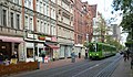 Limmerstraße mit einer ebenerdigen Stadtbahn-Haltestelle und dem Triebwagen TW 6000