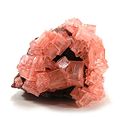 Image 11Pink cubic halite (NaCl; halide class) crystals on a nahcolite matrix (NaHCO3; a carbonate, and mineral form of sodium bicarbonate, used as baking soda). (from Mineral)