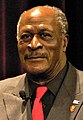 John Amos interpreta "Burt" Guster