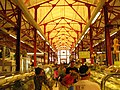 Meats, delicatessens, and other prepared food stands are inside the market.