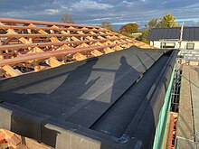 Photo of a small Butynol roof installation showing the seamless and smooth synthetic rubber membrane applied to a flat roof on a residential building in New Zealand