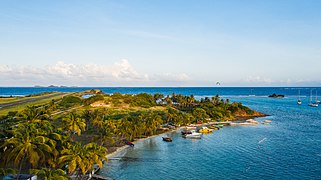 Areal view of a beach on Union Island near Clifton with the Union Island Airport in the background.