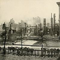 Smoke is still rising from the ruins of Richmond, Virginia after surrendering on April 3, 1865 following the Union victory at the Siege of Petersburg. Union cavalry mounts with carbines visible are hitched in the foreground.