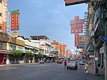 a Chinatown street with almost no car and people