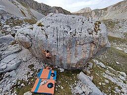 Man climbing a boulder